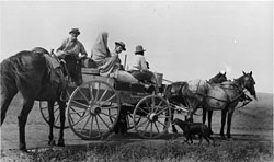 Crow's Heart, Mrs. Crow's Heart, Frances Densmore, and Charles Hall in a wagon