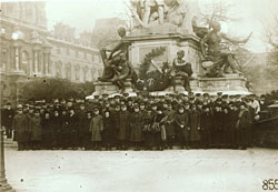 large group of Red Cross nurses, doctors, and support staff gathers for a portrait in Paris at the statue of Gambetta